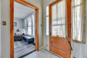 una puerta que conduce a una sala de estar con sofá en Tonawanda Apartment Steps to Niagara River!, en Tonawanda