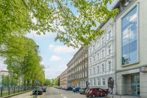 a city street with buildings and cars parked on the street at Toress Apartamenty plac Grunwaldzki in Szczecin