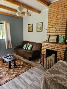 a living room with a couch and a fireplace at Casa Goethe - Bio Cult in Campo Alegre