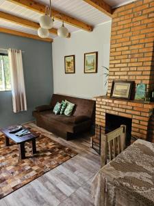a living room with a couch and a fireplace at Casa Goethe - Bio Cult in Campo Alegre
