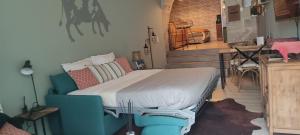 - une chambre avec un lit et une chaise dans l'établissement La Tannerie - BedinShop, à Romans-sur-Isère