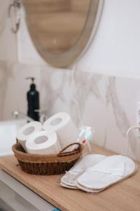 a basket of toilet paper on a counter with a mirror at Уютная и комфортная 3х комнатная квартира со всеми условиями in Uralsk