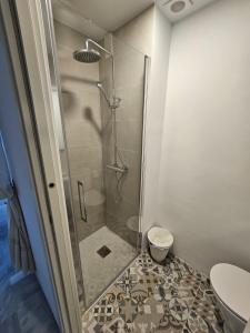 a shower stall in a bathroom with a toilet at Ático Molière Beach in Málaga