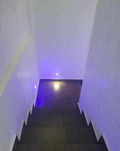 a staircase in a building with a blue light at Villa dream in Casablanca