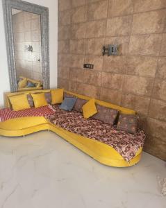 a yellow bed with pillows on it in a room at Villa dream in Casablanca