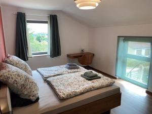 a bedroom with a bed and a window at Eifelvilla zur Kirsche - Wellness und Spa in Burbach