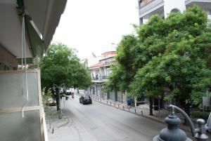 a city street with a car driving down the street at Mina's Spacious Studio Apt : June '23 Renovated in Thessaloniki