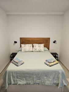 a bedroom with a bed with two towels on it at Ático Molière Beach in Málaga