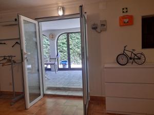 a door leading into a room with a bike on the wall at Villa Casa das Palmeiras in Charneca