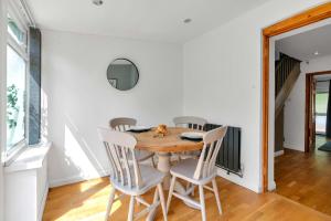 a dining room with a wooden table and chairs at The Retreat on Risbygate in Bury Saint Edmunds