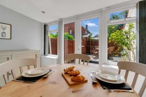 a dining room with a wooden table and chairs at The Retreat on Risbygate in Bury Saint Edmunds