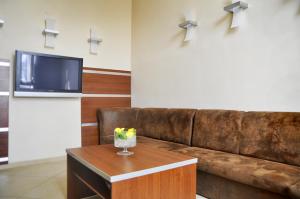 a living room with a brown couch and a table at Brojan in Jaworzno