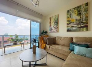 a living room with a couch and a table and a large window at Encanto Urbano in San Salvador