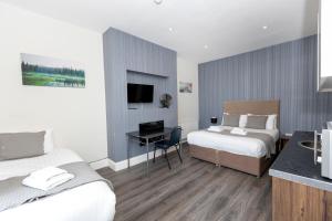 ロンドンにあるW6 Hotelのベッド2台とデスクが備わるホテルルームです。