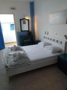 a bedroom with a bed with towels on it at Aigaio studios & rooms in Azolimnos