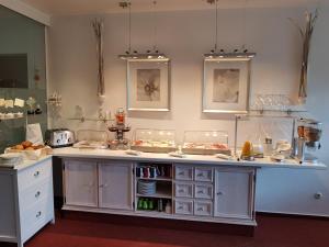a kitchen with a counter with food on it at Hotel Garni Waldsegler in Bad Sachsa