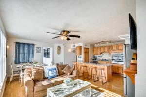a living room and kitchen with a couch and a table at Ormond Beach Home: Walk to Community Beach! in Ormond Beach