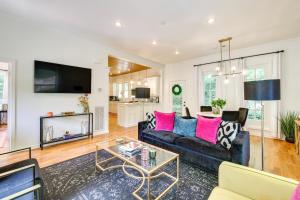 a living room with a black couch and pink pillows at Eureka Springs Vacation Rental Less Than 1 Mi to Downtown in Eureka Springs
