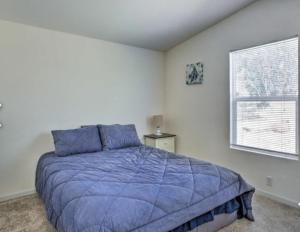 a bedroom with a blue bed and a window at Blue Mountainview in Mariposa