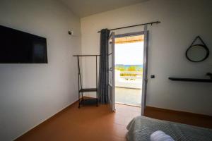 a room with a room with a sliding glass door at AzosunApartment3 in Azolimnos Syros