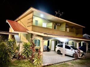 a car parked in front of a house at night at Maze Roomstay Langkawi in Pantai Cenang