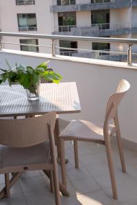 una mesa y sillas en un balcón con una planta en Lulu Suites - Sunflower, en Golem