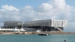 a large building with a boat in the water at APPARTEMENT 2 CHAMBRES A POINTE A PITRE in Pointe-à-Pitre