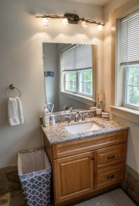 a bathroom with a sink and a mirror at Mockingbird Mountain Spa and Retreat in Luray