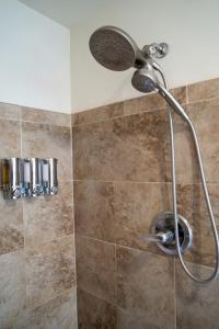 a shower with a shower head in a bathroom at Mockingbird Mountain Spa and Retreat in Luray
