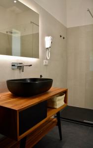 uma casa de banho com um lavatório preto num balcão de madeira em Monterosso Rooms em Monterosso al Mare