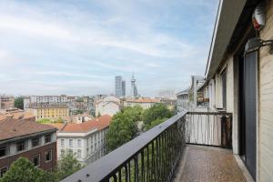 a balcony with a view of a city at Easylife - Elegante attico 2 min da Parco Sempione in Milan