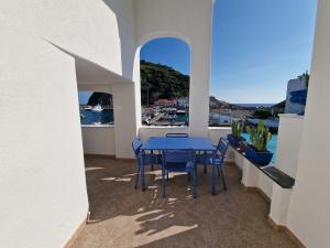 a table and chairs on a balcony with a view of the water at Casa Dei Nonni in Ischia