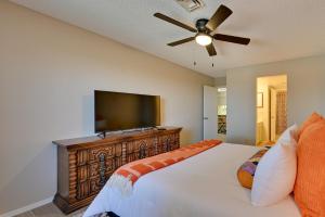 a bedroom with a bed and a flat screen tv at Cozy Arizona Retreat with Pool Access, Patio and Grill in Yuma