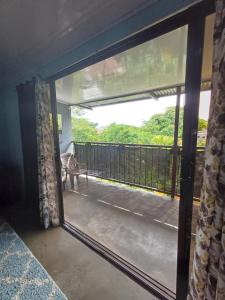 a sliding glass door with a view of a balcony at House la Rosa third floor 5 in Quepos +5 photos
