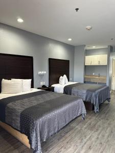 Кровать или кровати в номере Atlantis Inn Suites