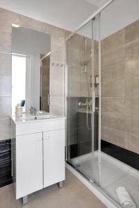 a white bathroom with a shower and a sink at Sunny Suites Lisbon in Lisbon