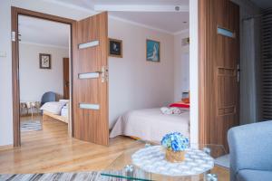 a bedroom with a bed and a large wooden door at Noclegi U Fela in Ustrzyki Dolne