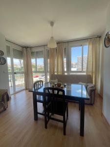 a living room with a table and a couch at Piso con parking y piscina en Torrox costa in Torrox Costa