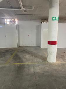 an empty room with white walls and a red and white pole at Piso con parking y piscina en Torrox costa in Torrox Costa
