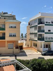 a view of two apartment buildings and a parking lot at Piso con parking y piscina en Torrox costa in Torrox Costa