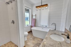 a bathroom with a tub and a toilet and a sink at Three Bears Get Away farmhouse in Hamilton