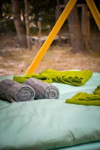 a pile of blankets sitting on a swing at Čiki Puki Glamping in Palanga