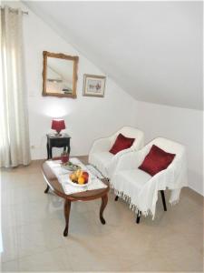 ein Wohnzimmer mit einem Tisch und 2 Stühlen in der Unterkunft Apartments Song in Split