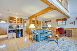 a living room with a blue couch and a table at Vacation Rental Home in the Berkshires! in Williamstown