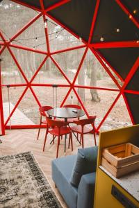 a room with a table and chairs in a tent at Čiki Puki Glamping in Palanga