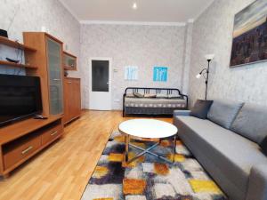 a living room with a couch and a table at Large and cozy apartment in the center of Karlovy Vary in Karlovy Vary