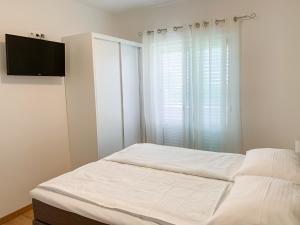 Postel nebo postele na pokoji v ubytování Haus Lupić