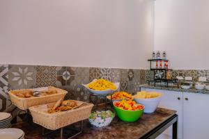 a kitchen with baskets of food on a counter at Grand Muthu Forte Da Oura in Albufeira