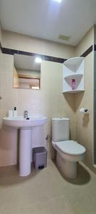 a bathroom with a toilet and a sink at Apartamento Arena y Sal - Garrucha in Garrucha +21 photos