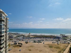 a view of a beach and the ocean from a building at Ducks on the beach in ‘Akko